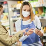 Adult woman in medical mask shopping for groceries