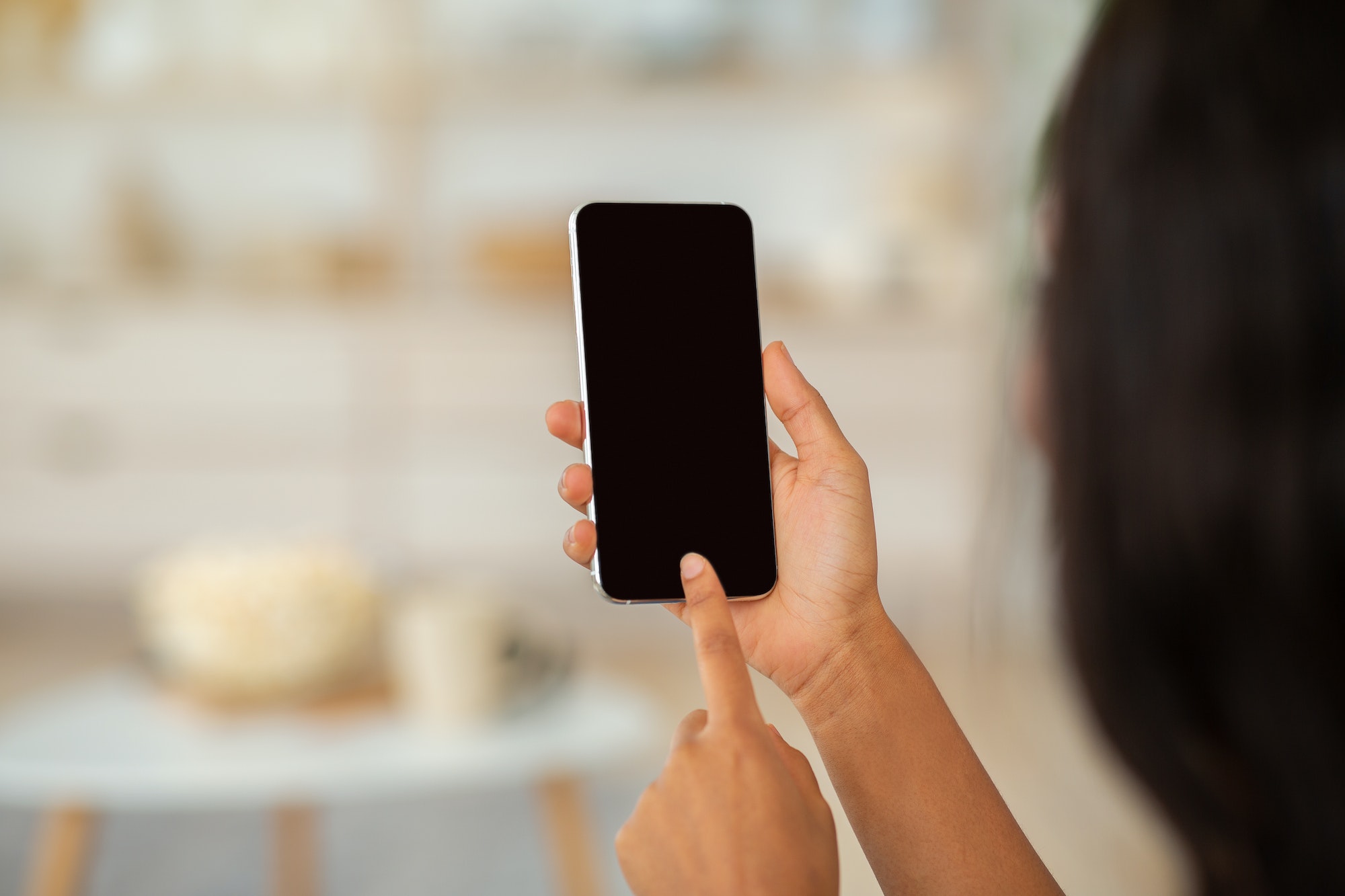 African American woman touching mobile phone screen with mockup for mobile app or website design