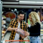 Couple in a supermarket with shopping cart while grocery shopping