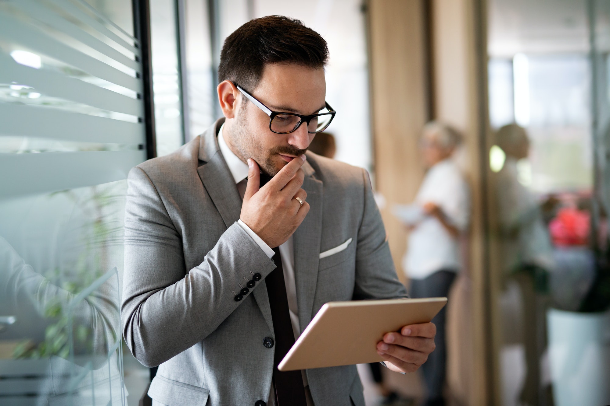 Young happy business woman working with tablet in corporate office